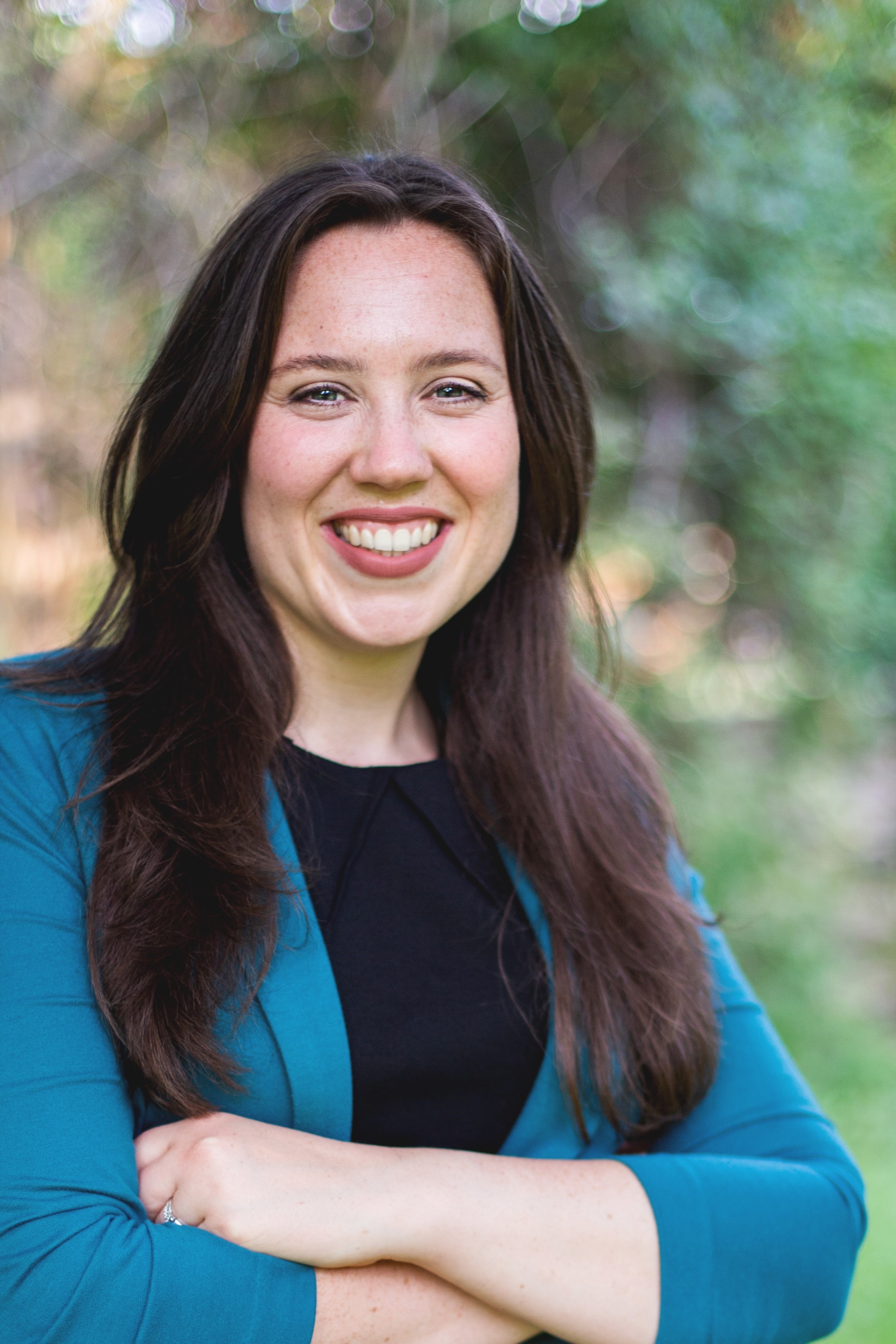 Headshot of a.	Hannah Debelius in an outdoor setting.