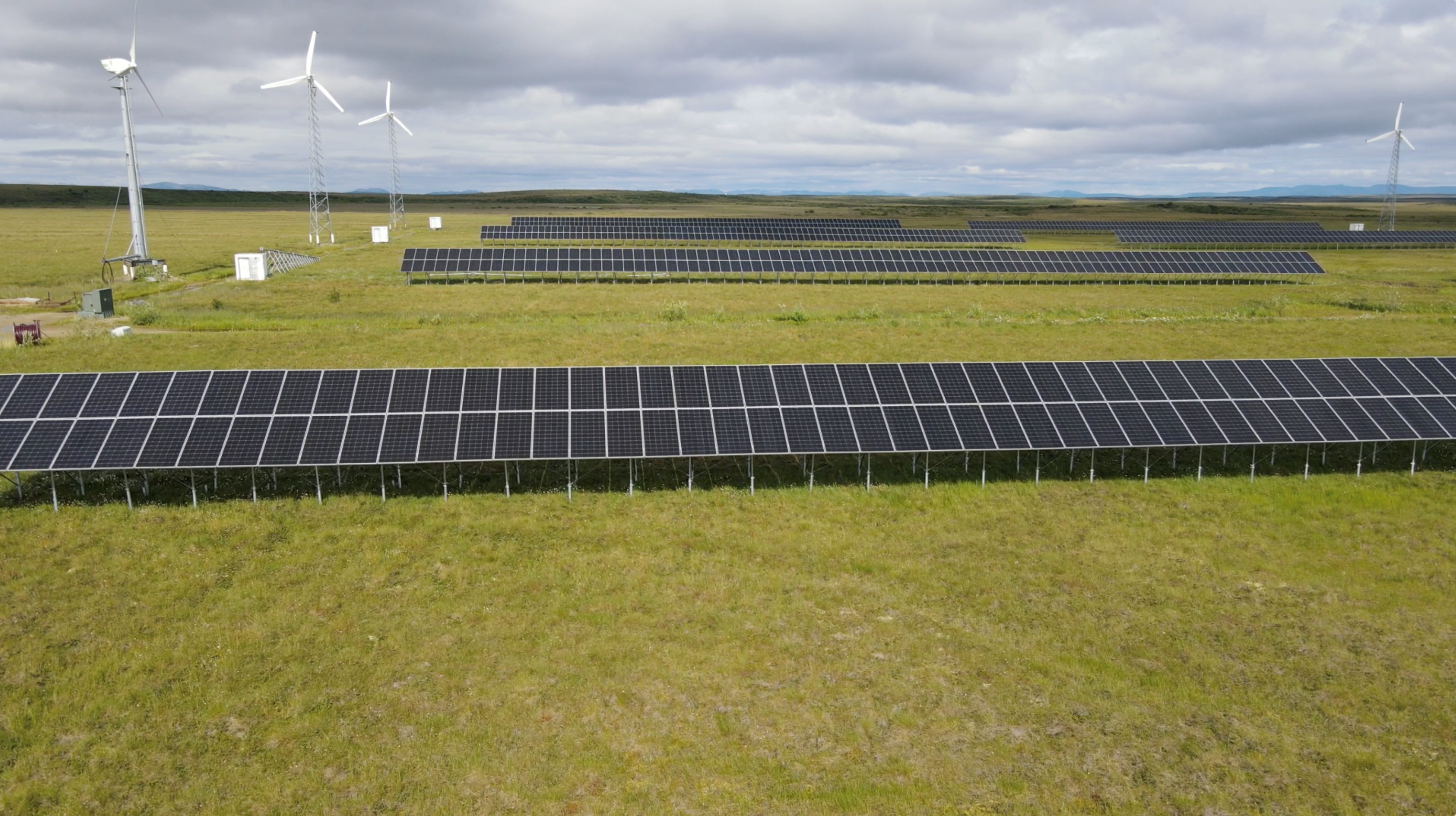 Solar array with wind turbine in the background in Kotzebue, Alaska. 