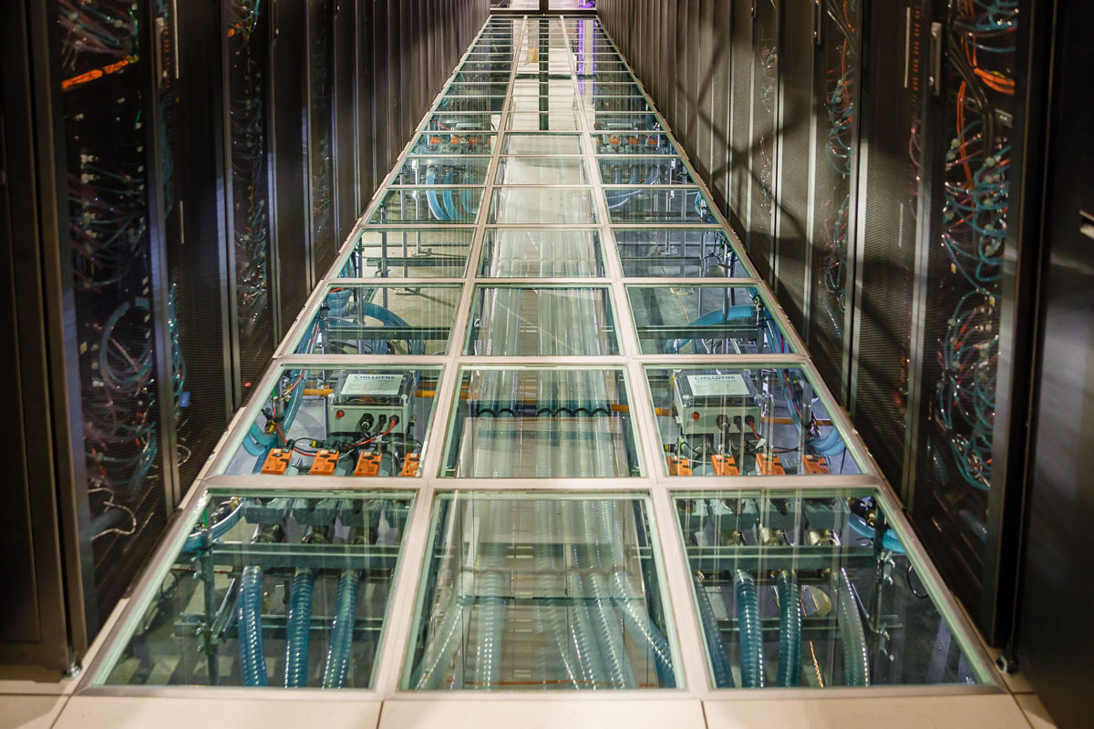 In the data center, water rushes through tubes and computer racks, providing a warm-water cooling system and keeping the high-performance computers from overheating.