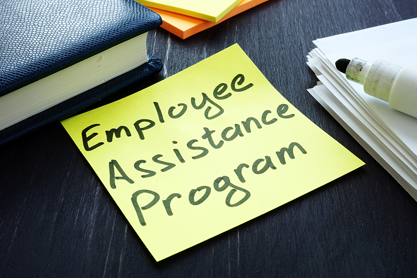 Desktop with a Post-It note that reads Employee Assistance Program