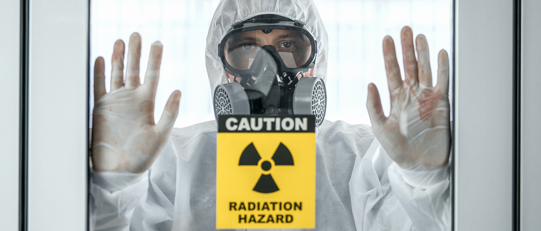 main in protective gear,with yellow and black radiation hazard symbol and text