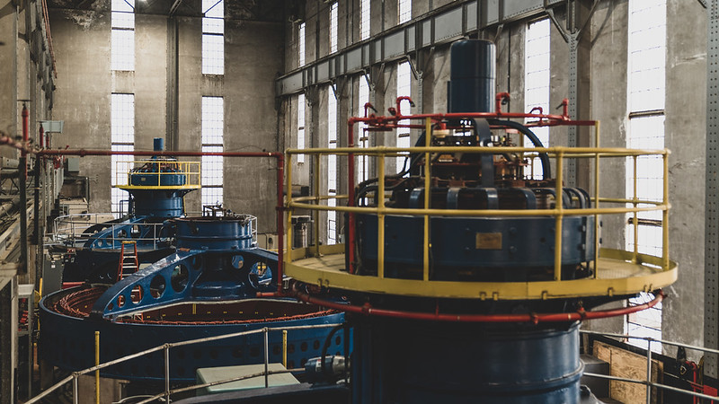 Turbines for a hydropower facility located inside a large, concrete, industrial-looking structure. Source: 