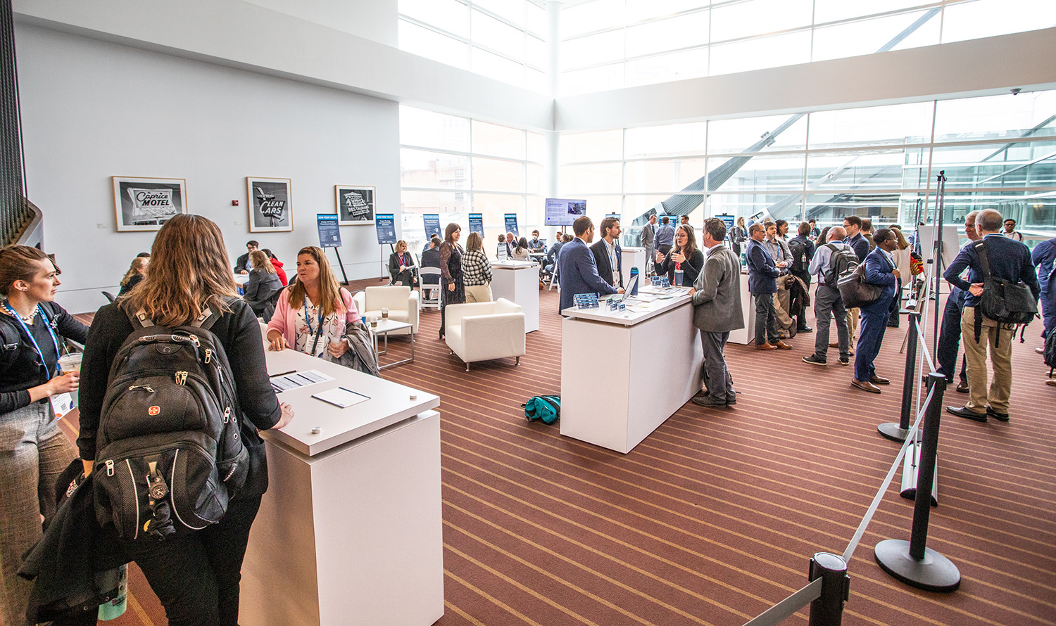 Several attendees at the 2024 Energy Exchange event are engaging group conversations in the Federal Energy Management (FEMP) Hub space, where they can talk with other agencies and FEMP experts.