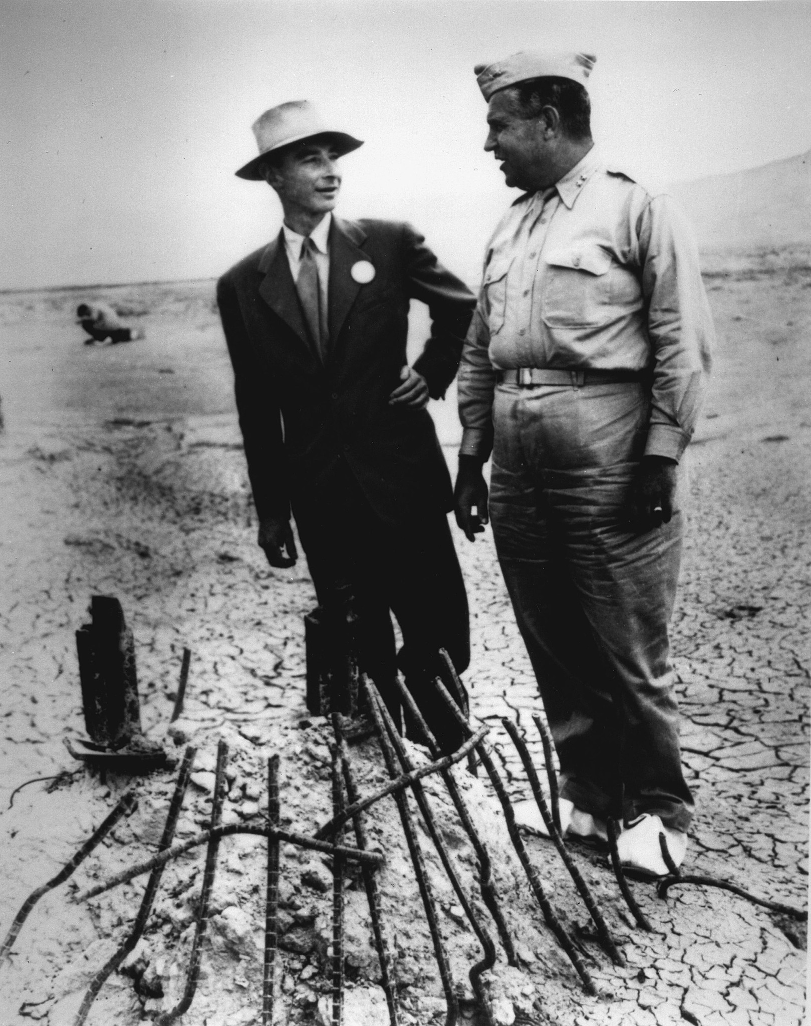 Black and white photo of Oppenheimer at the test site.