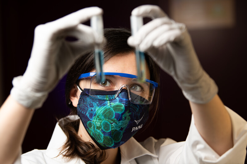 Women holding pipets in lab