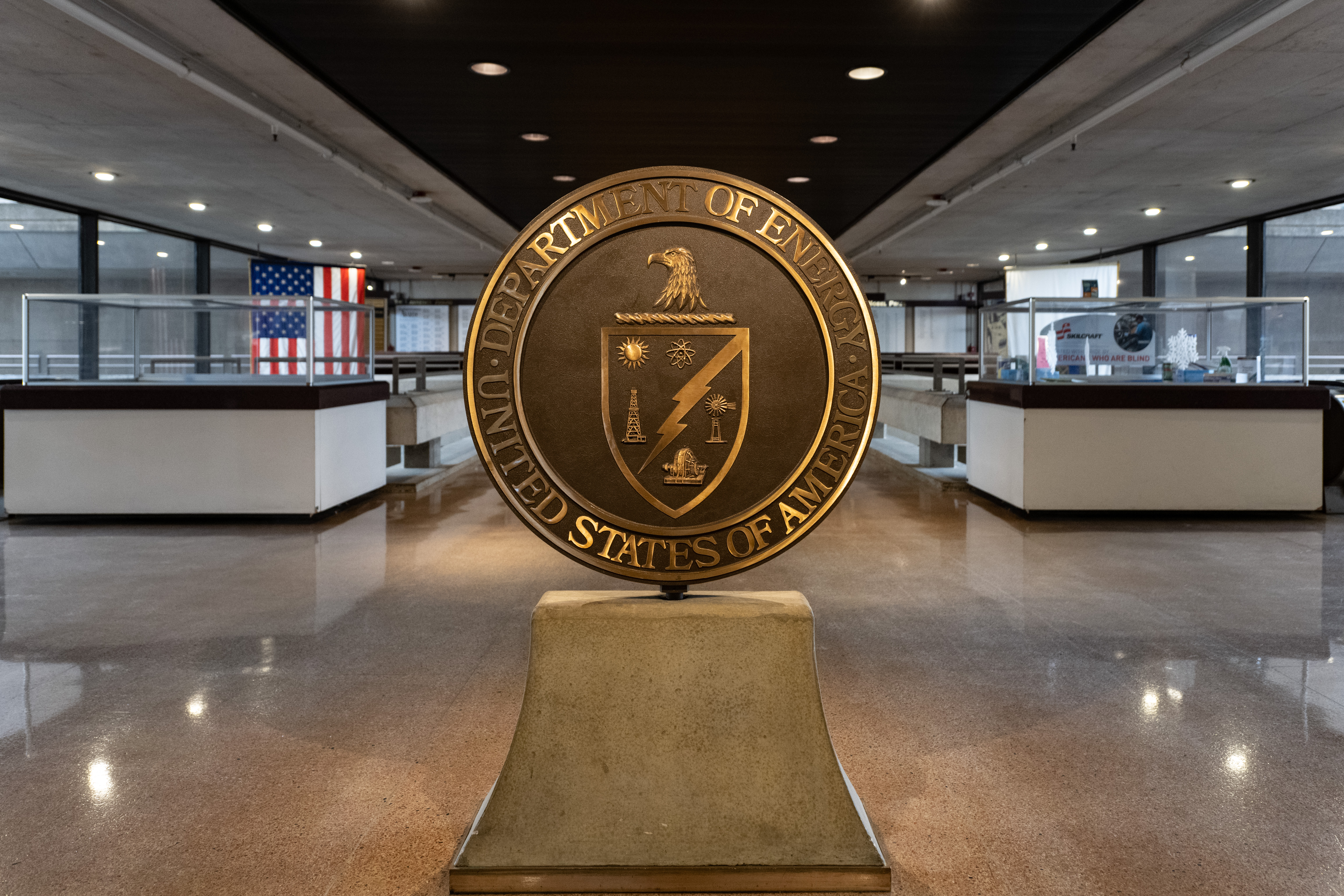 Photo of a large bronze statue of the DOE seal, located inside DOE Headquarters in Washington, D.C.