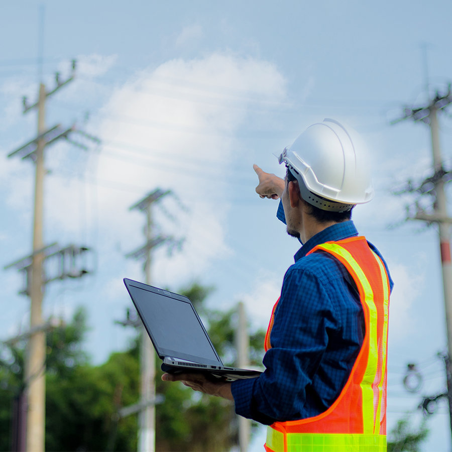 Electricity worker with distribution lines in background