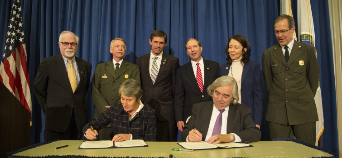 Photo of Secretary of the Interior Sally Jewell and Secretary Ernest Moniz signing a memorandum establishing the Manhattan Project National Historical Park.