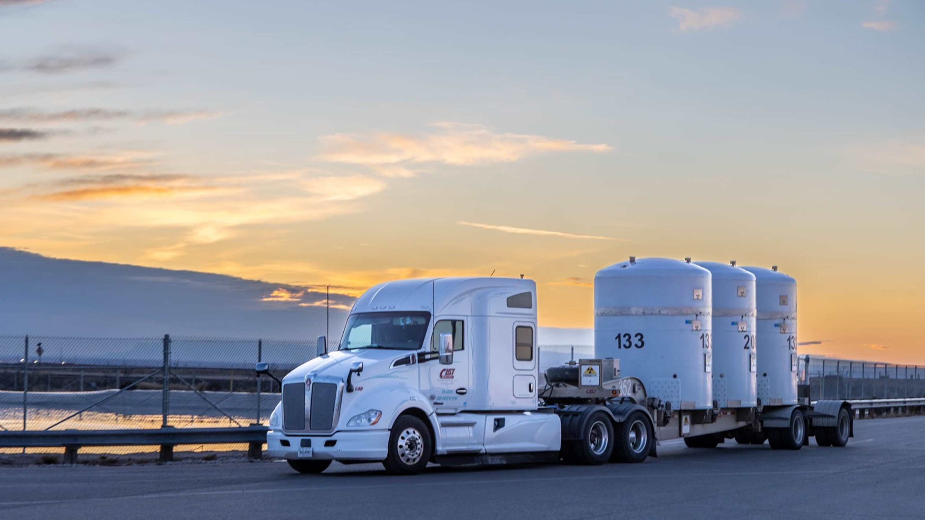 A large truck carrying three large shipping containers. 