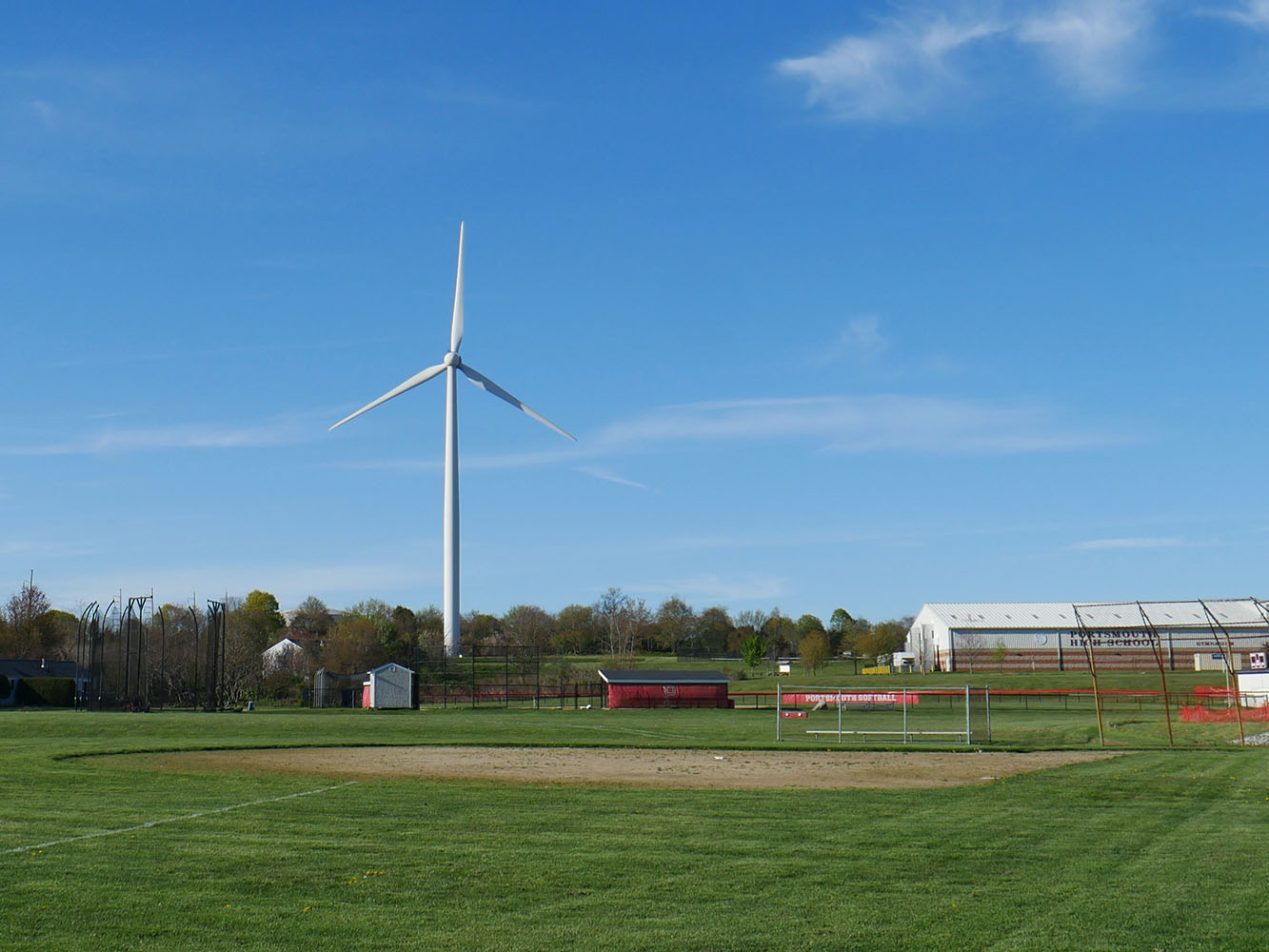 Wind turbine on a field next to a farm