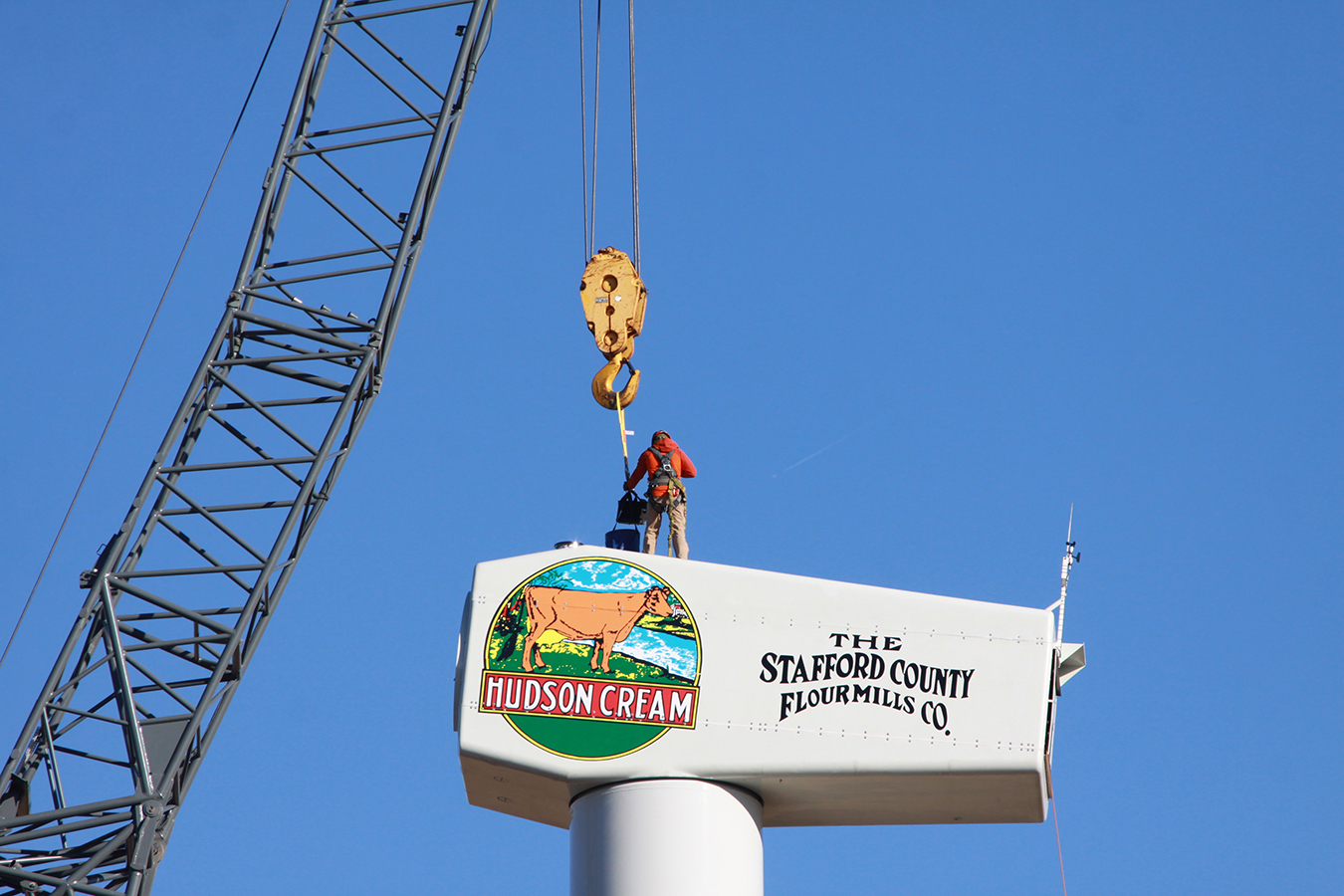 Man is in the air building a wind turbine