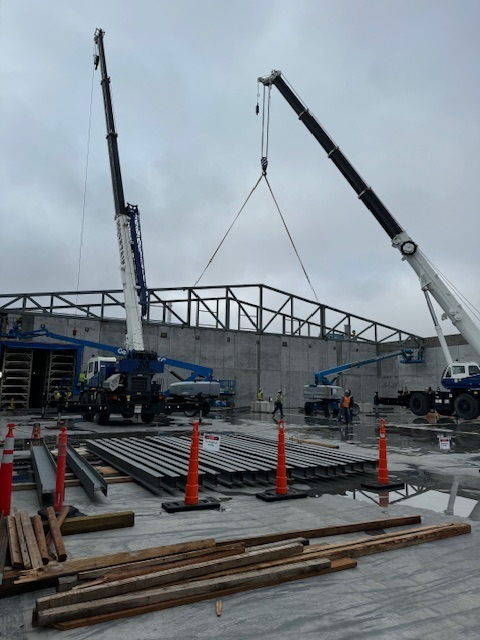 A crane placing parts of a building