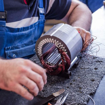 Person working on a electromagnetic coil