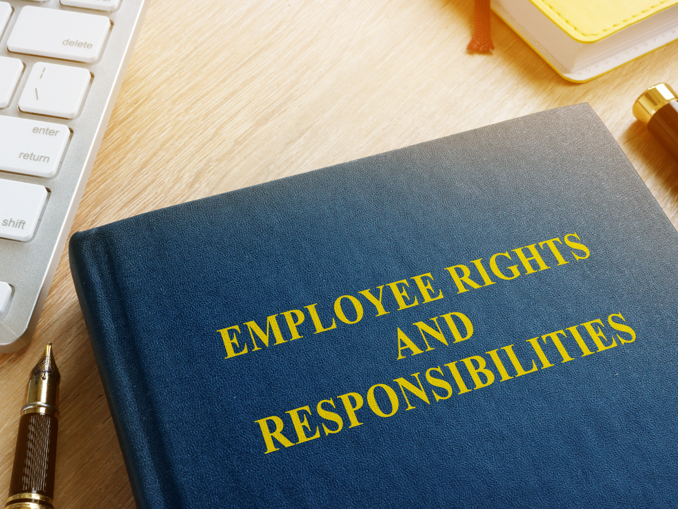 Blue book with Employee Rights and Responsibilities written in yellow font