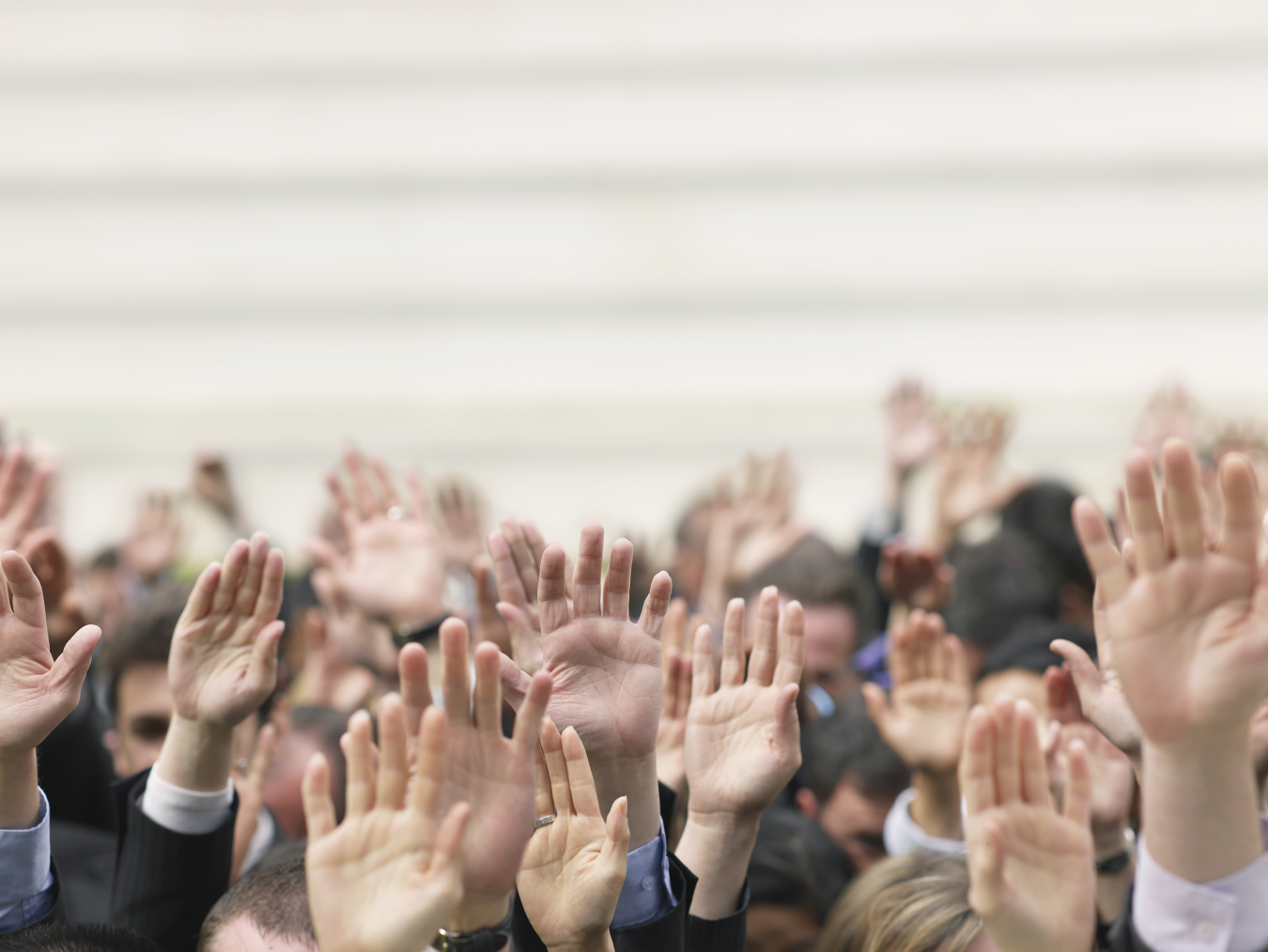 Group of people with their hands raised