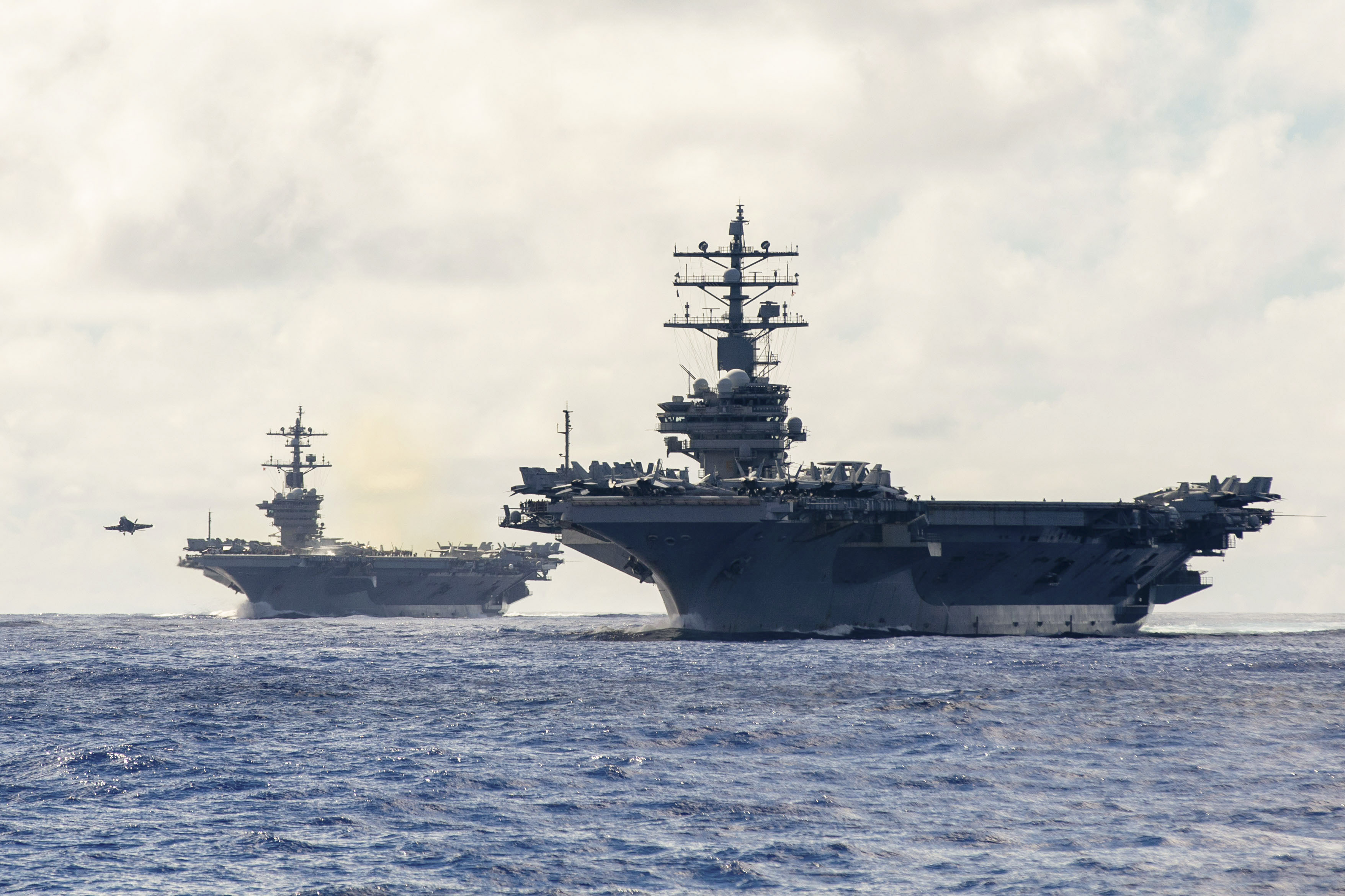 Two air craft carriers on ocean horizon