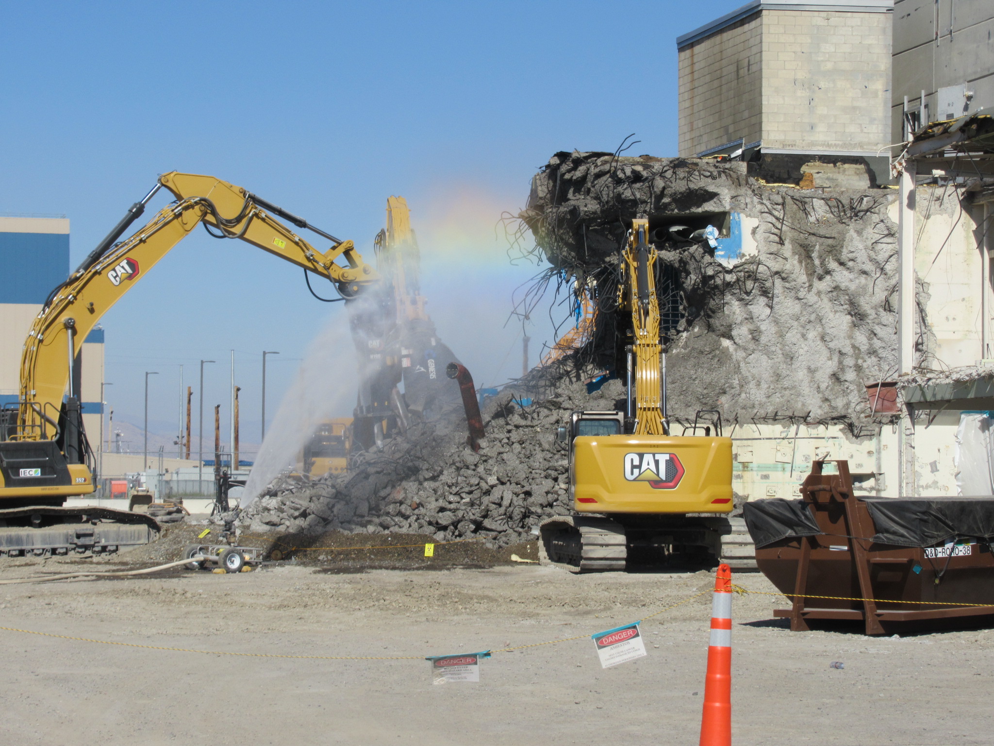 Work vehicles demolish a hot cell building 