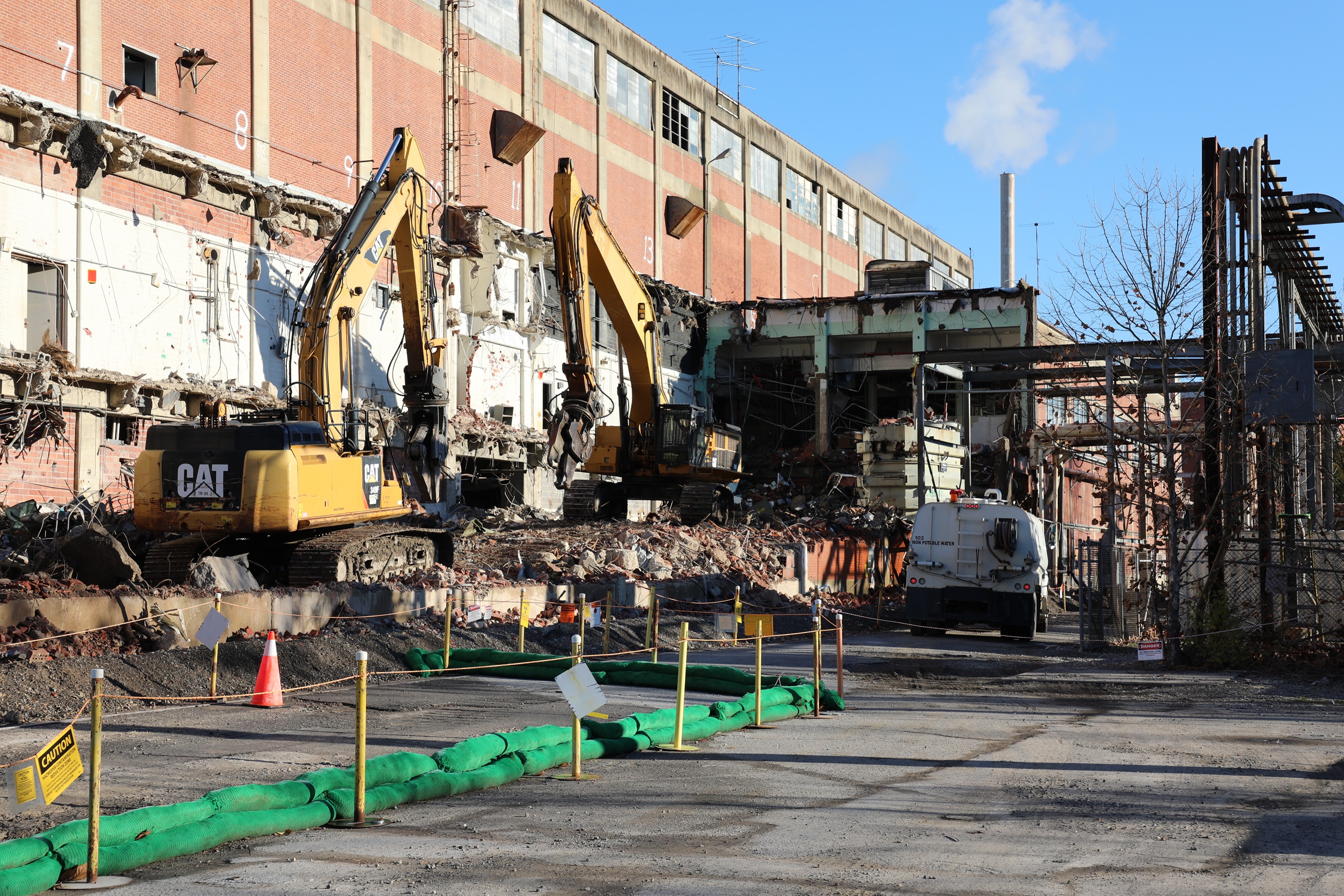 Demolition site with a demolished building and heavy machinery 