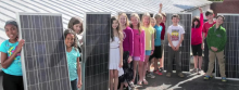 school children displaying solar panels