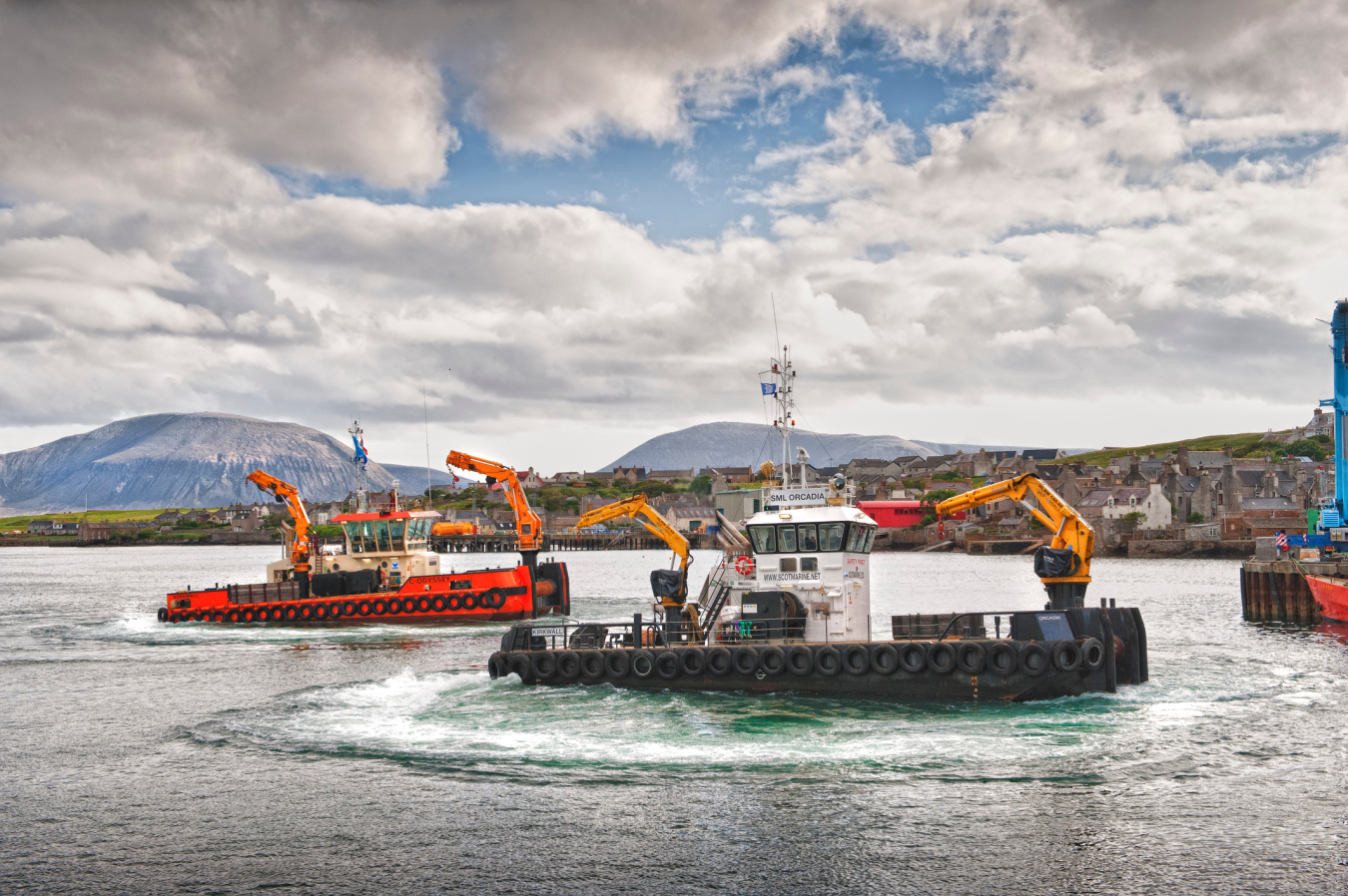 Supply chain vessels by a hilly Scottish town.