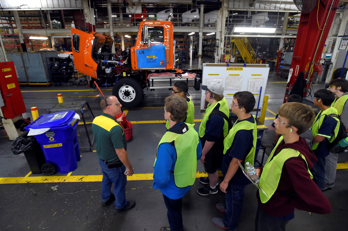 a photo of people standing in a manufacturing facility