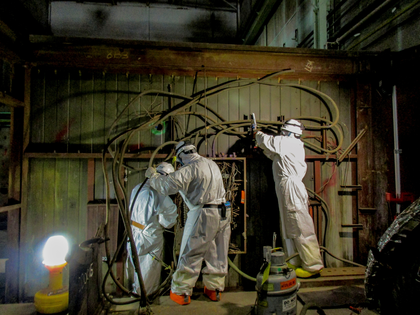 Four Rivers Nuclear Partnership workers remove instrument lines and electrical conduit from the C-400 Cleaning Building.