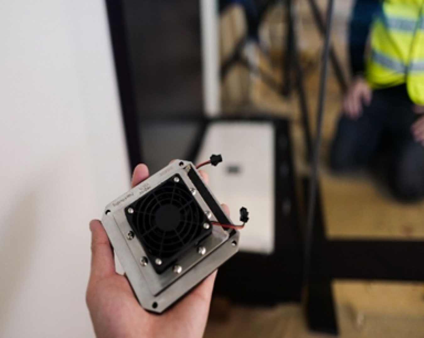 Hand holding the electrochemical humidity control device prior to installation at the Statue of Liberty Museum. 