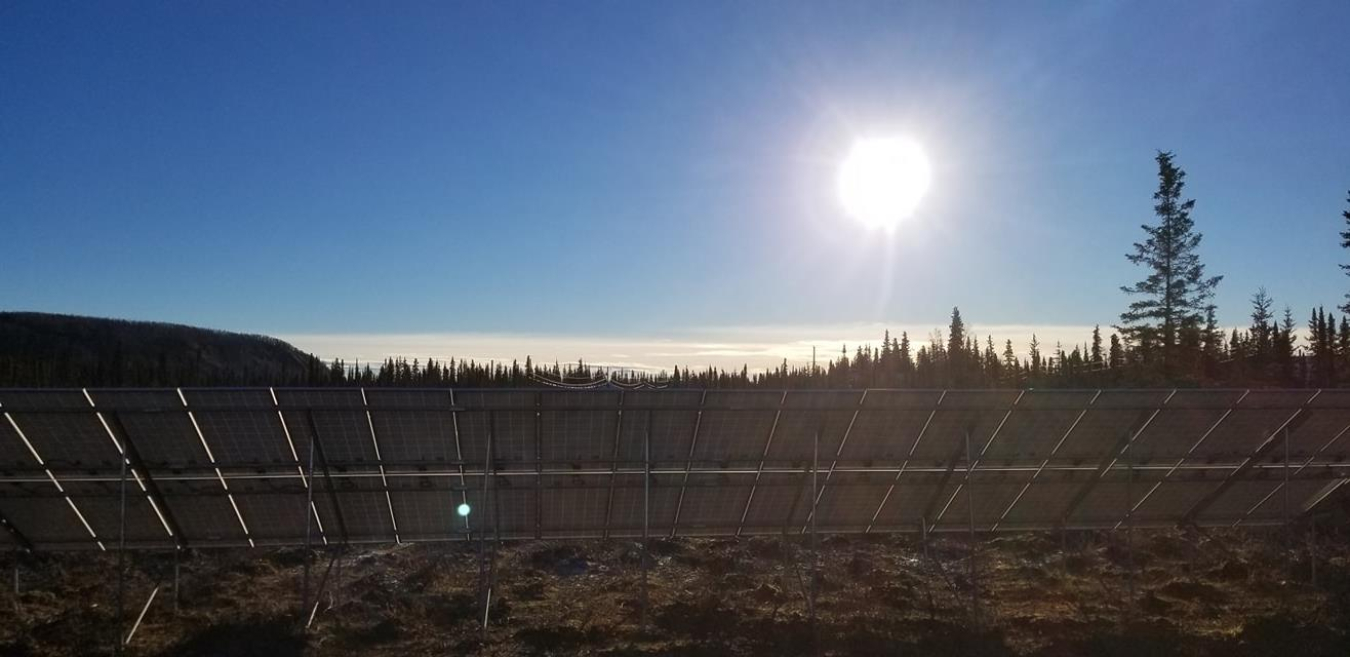 A row of solar panels shining in the sun.