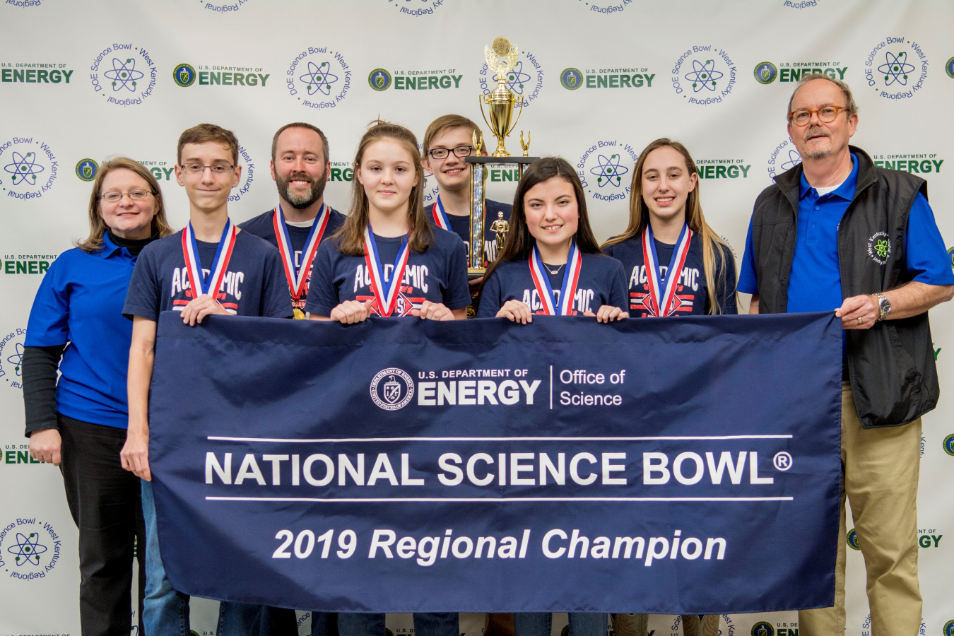 Calloway County Middle School, First Place: Front row, pictured left to right: Ethan Cain, Rebecca Grosz, Drake Calhoon, Emma Arnett. Back Row: Jennifer Woodard, DOE Paducah Site Lead, Scott Pile, Calloway County Middle School Coach, Isaac Martin, Buz Smi