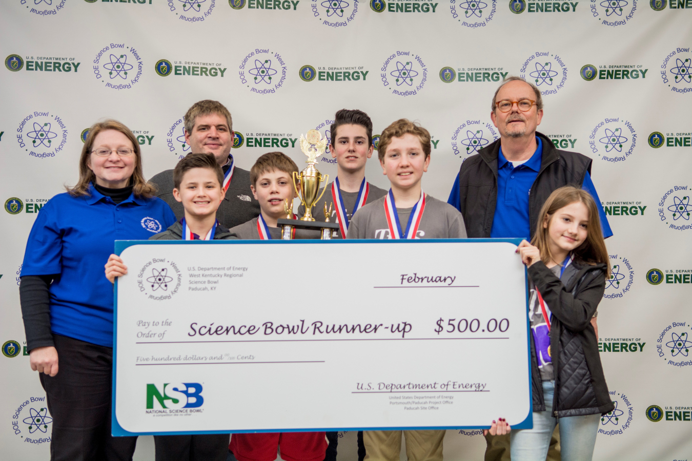 Lone Oak Middle School, Second Place: Front row, pictured left to right: Nolan Short, Ben Frederich, Owen Cody, Evie Maddox; Back row: Jennifer Woodard, DOE Paducah Site Lead, Daniel Rushing, Lone Oak Middle School Coach, Carter McReynolds, Buz Smith, DOE