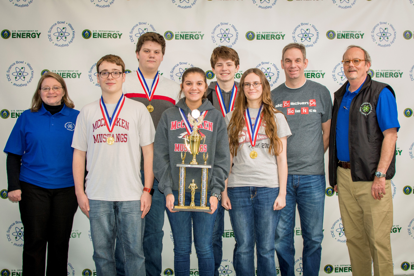 cCracken County High School: (Front row, l-r) Jennifer Woodard, DOE Paducah Site Lead, Xander Norment, Ella McBee, Evie Dukes. Back row: Jake Mitchell, Mason Wooten, Matt Shelton, MCHS Coach and Buz Smith, DOE Science Bowl Coordinator