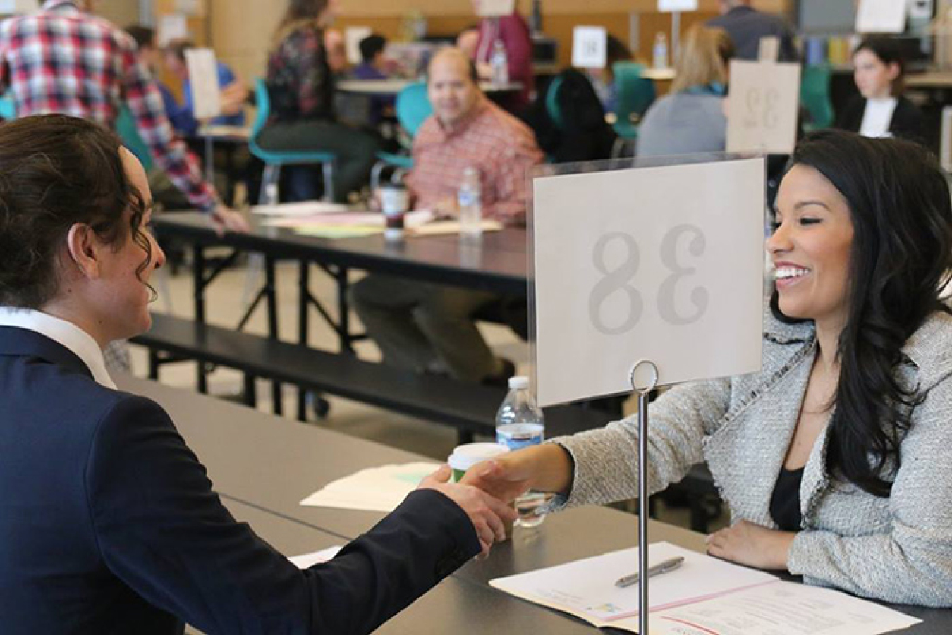 Jessica Esparza, a staffing specialist with MSA, right, assists a high school student with a mock interview and resume advice.