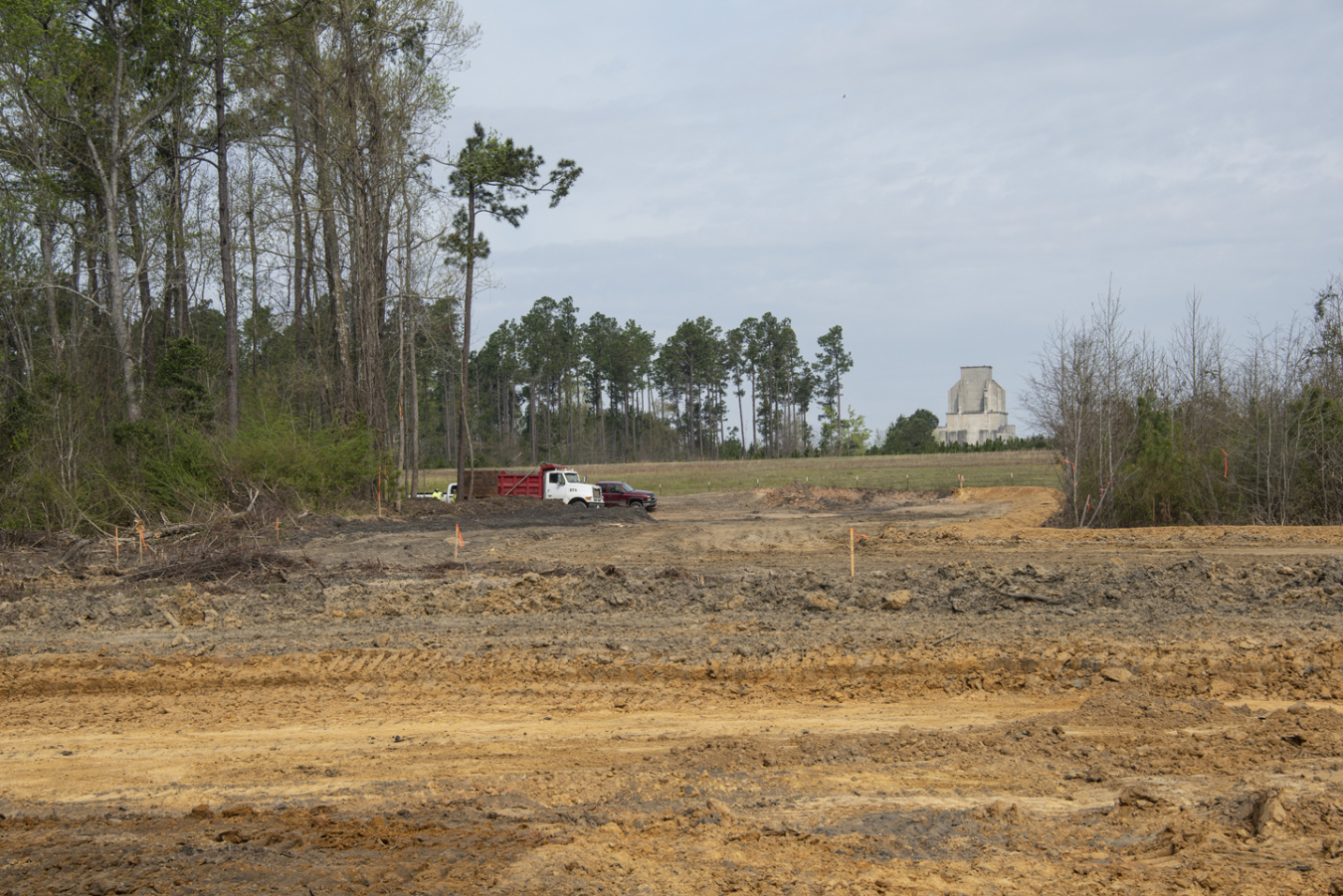 Heavy equipment is used to remove soil and ash one acre at a time to minimize erosion. The decommissioned P Reactor is in the background.