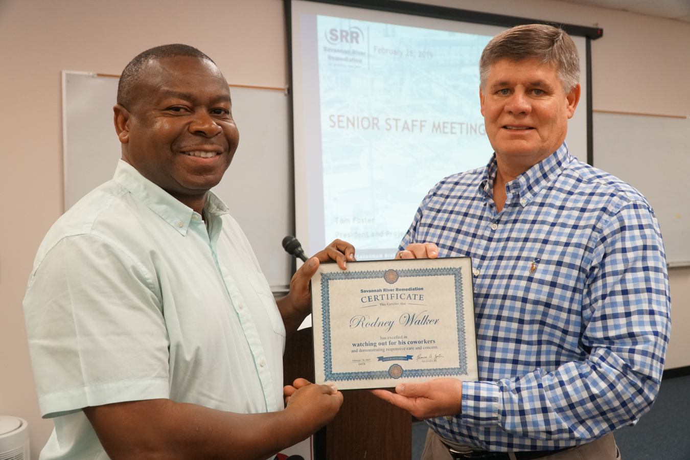 Savannah River Remediation President and Project Manager Tom Foster, right, recognizes SRR Senior Project Advisor Rodney Walker for his role in helping a coworker who needed emergency medical attention.