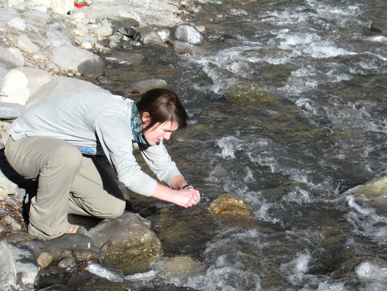 Lauren Wheeler is collecting water samples in the Himalaya for isotopic analysis. 