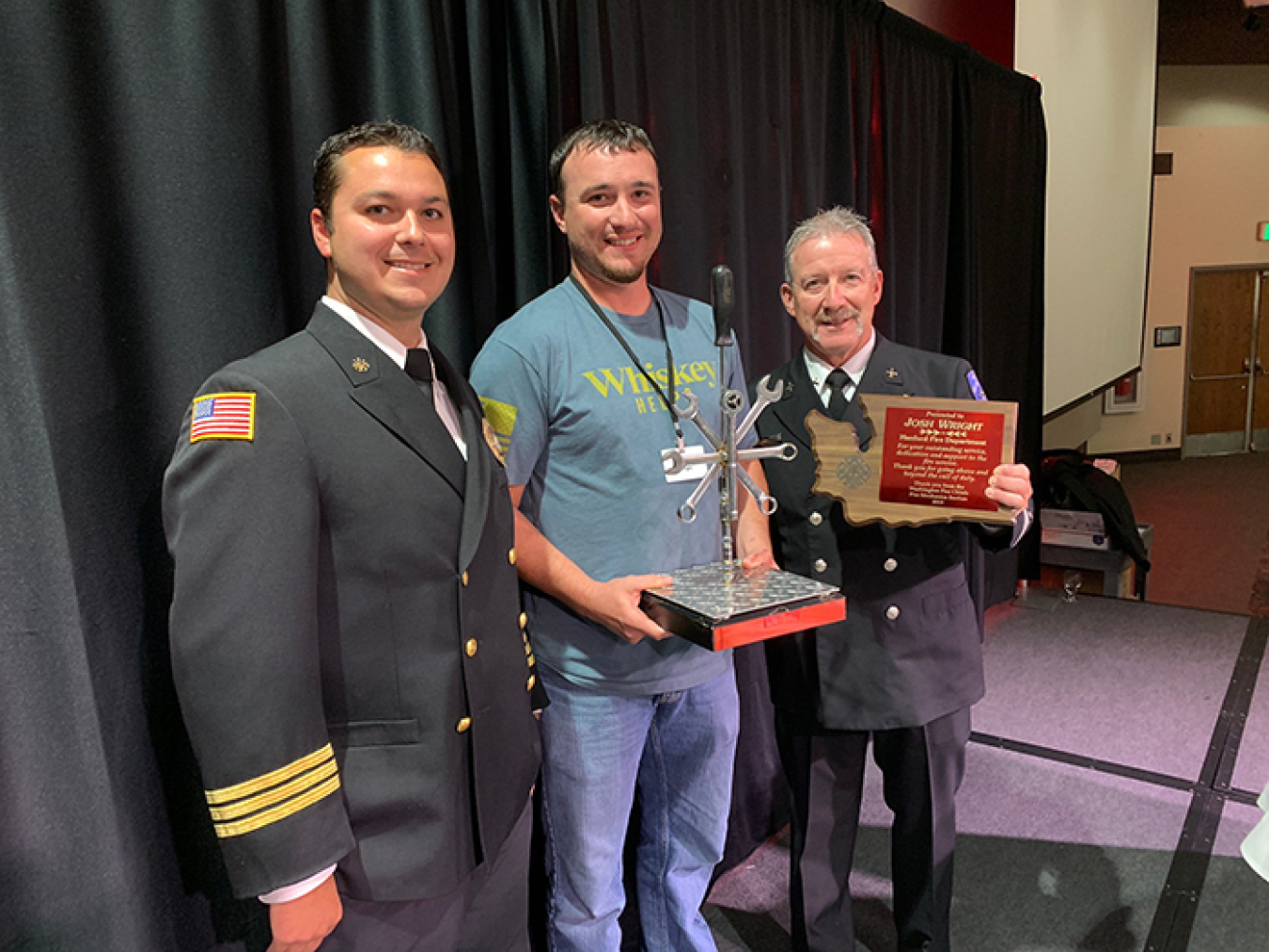 Mission Support Alliance fire mechanic Joshua Wright, center, receives the 2019 Washington State Fire Mechanic of the Year award. Also pictured are the Hanford Fire Department's deputy fire chief Adam Moldovan, left, and battalion chief Mark Cope.