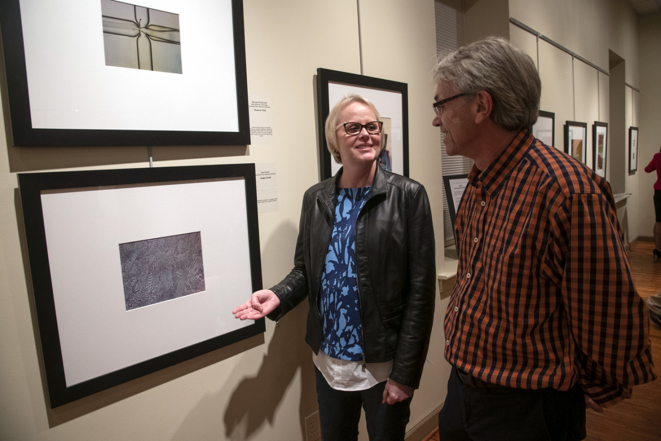 Savannah River National Laboratory (SRNL) employees Carol Kestin and John Gordon take a look at Kestin’s photograph “Dragon Scale,” during the opening of the Snap SRS art contest exhibit at the Aiken Center for the Arts (ACA).