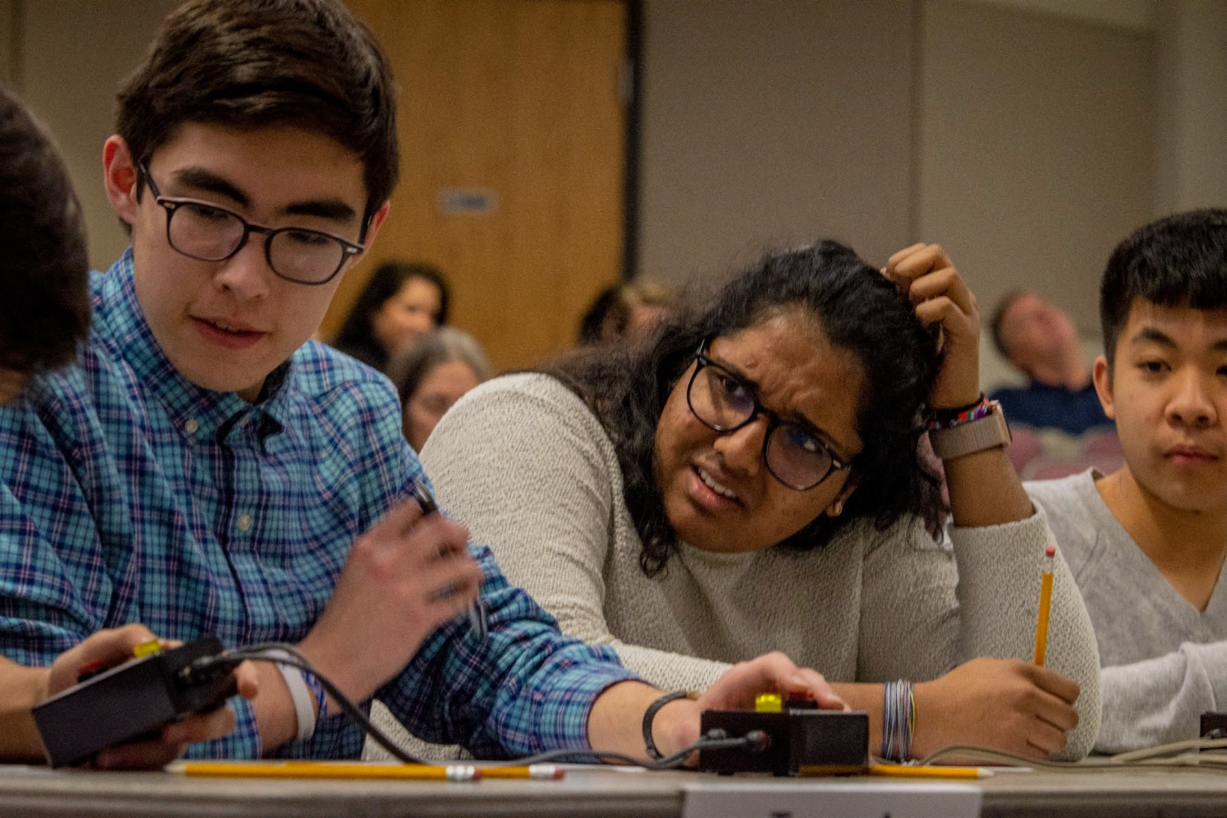 Gatton Academy students David Suarez, Hasitha Ramisetti and Jason Zhang compete in a quick-recall, fast-paced question-and-answer contest.