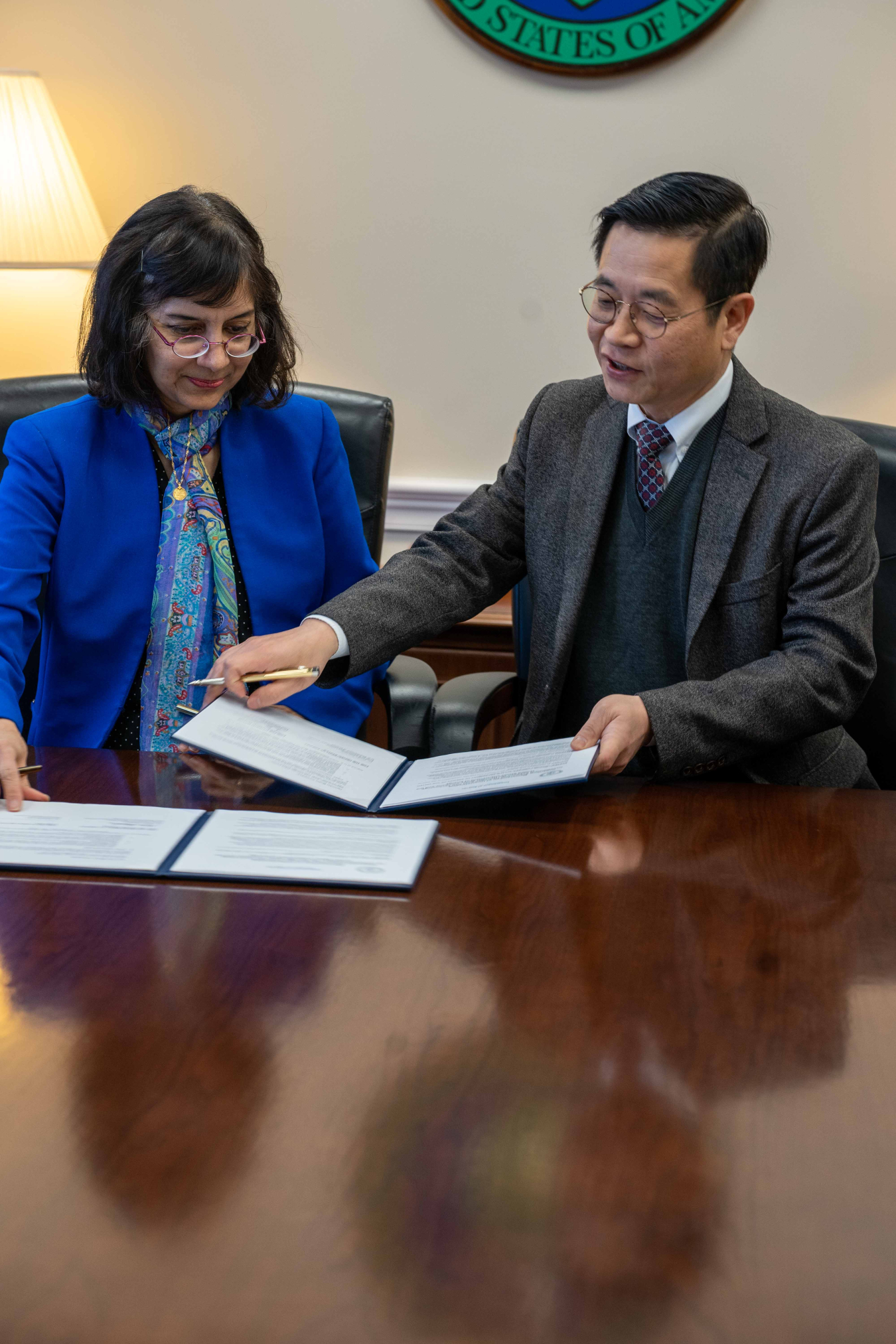 Hydrogen and Fuel Cells Program Director Sunita Satyapal signs a Memorandum of Understanding alongside a representative from Hyundai Motor Company.