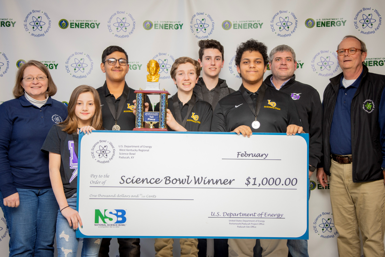 Lone Oak Middle School Team One took first place. Pictured left to right: DOE Paducah Site Lead Jennifer Woodard, Evie Maddox, Manav Shah, Owen Cody, Carter McReynolds, Cole Cannon, Coach Daniel Rushing and DOE Strategic Planner Buz Smith. 