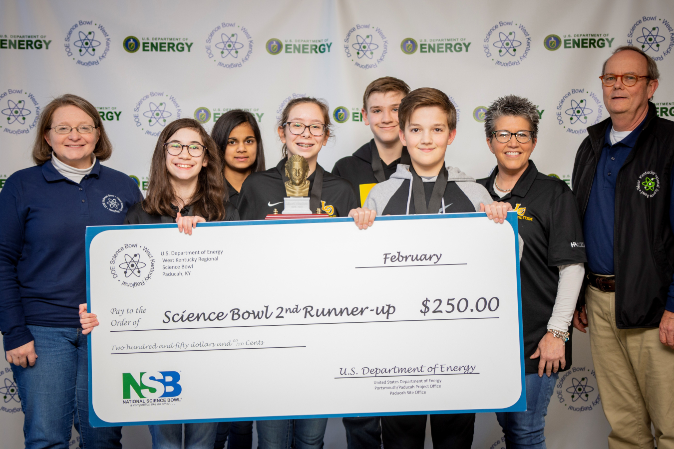 Lone Oak Middle School Team Two took third place. Pictured left to right: DOE Paducah Site Lead Jennifer Woodard, Ella Chuppe, Pratha Patel, Meg Kitchen, Carson Wallace, Kendrick Dunning, Coach Jacqueline Jones and DOE Strategic Planner Buz Smith. 