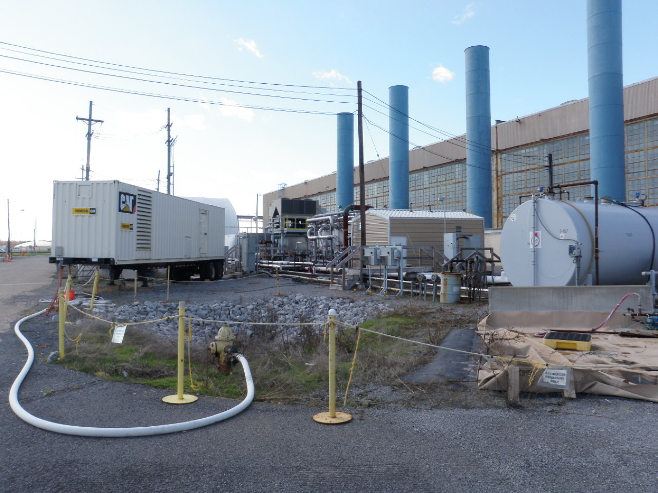 BEFORE: Pictured here are the equipment, tanks, and other items on the east side of the C-400 Building.