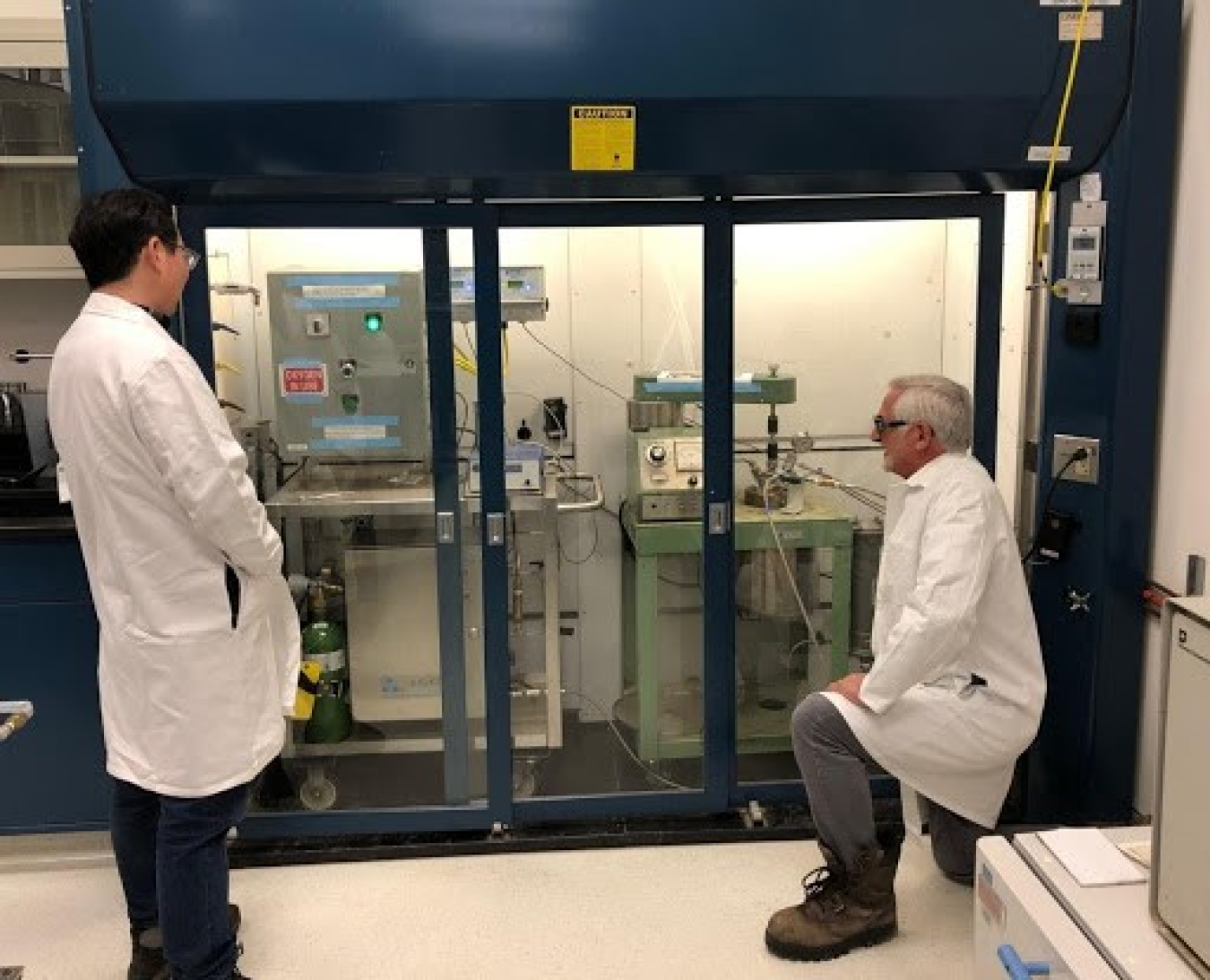 2 researchers looking at a ozone concentration in the pretreatment reactor