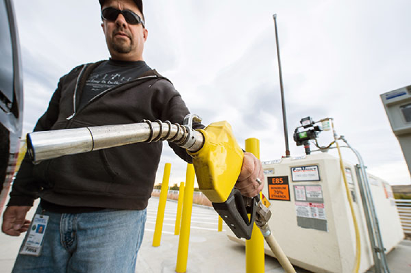 Man wearing sunglasses pumping E85 fuel.