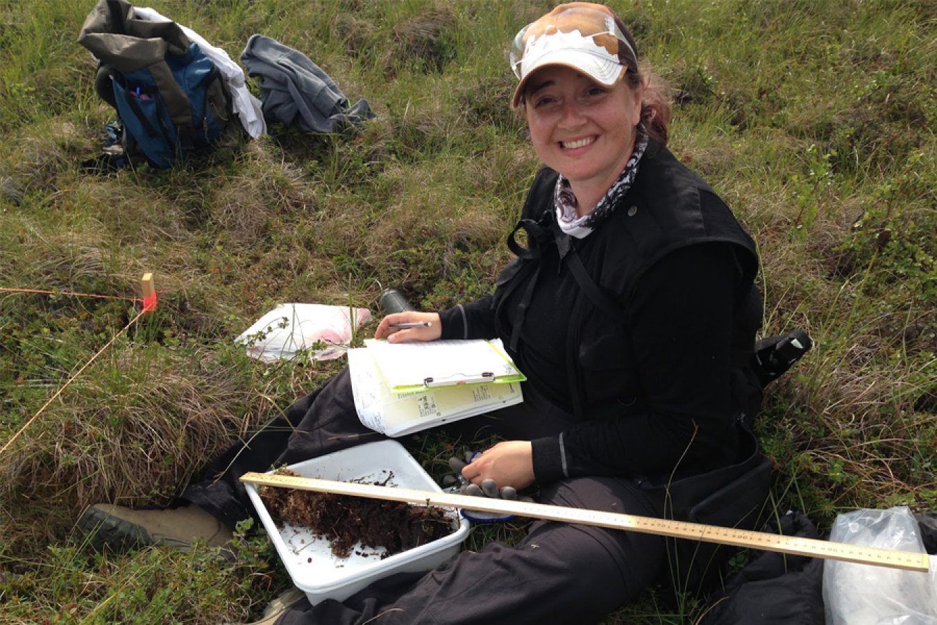 Colleen Iversen from Oak Ridge National Laboratory holds a soil core in the Alaskan tundra.