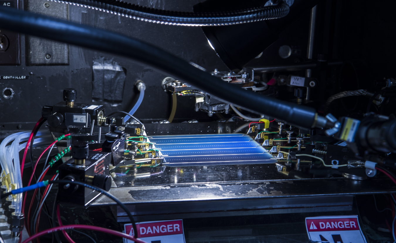 Paul Ndione from the Cell Performance Measuring group at NREL, measures a cell's efficiency using the X25 Solar Simulator in their lab at the SERF.