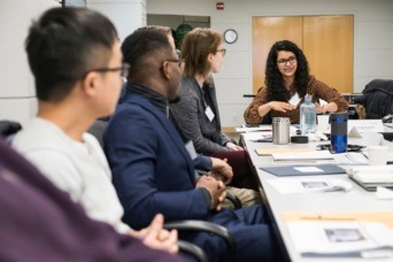 A group of people interacting at a long table.