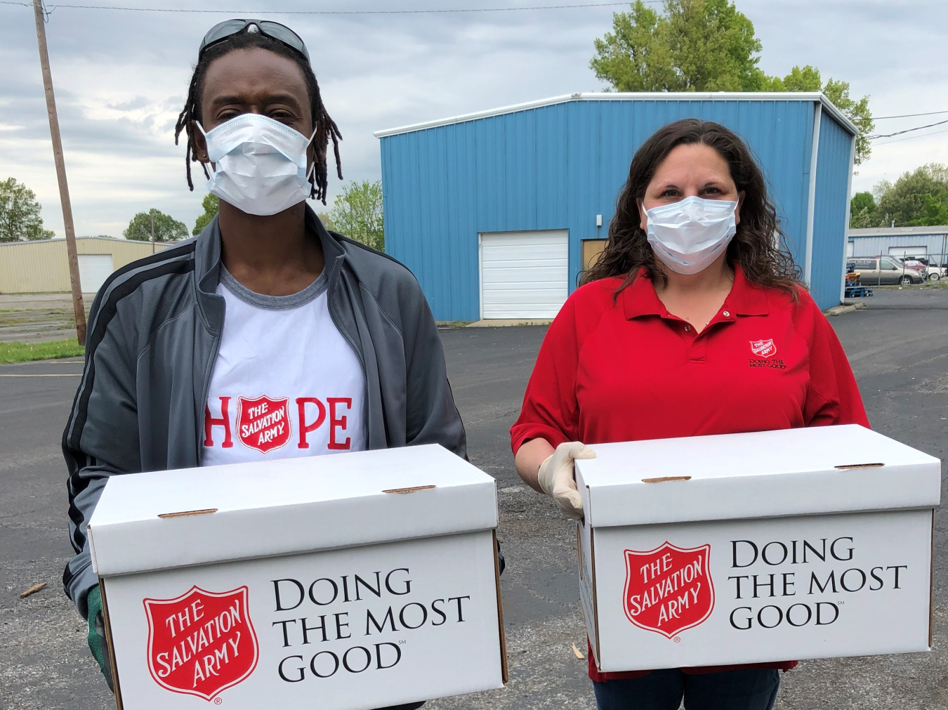 Salvation Army employees Jeffrey English and Mindy Reid distribute food boxes curbside to limit contact during the pandemic. 