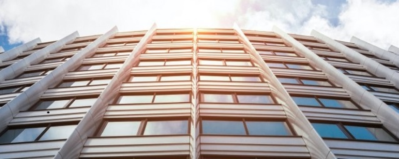 Exterior of a high-rise commercial building, at an angle looking up.