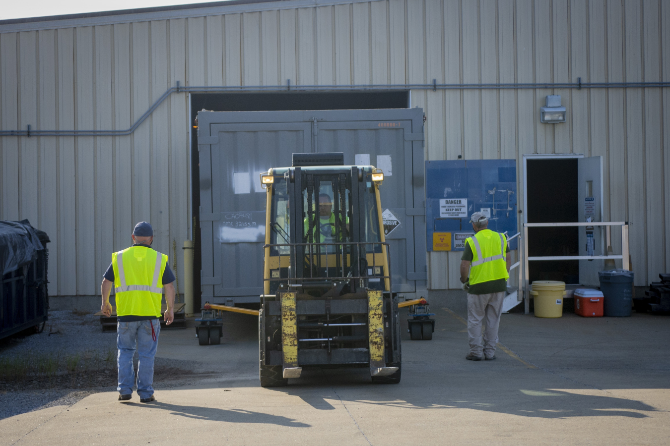 Paducah Site contractor operator Brad Story uses a forklift to move a cold trap out of the waste storage facility.